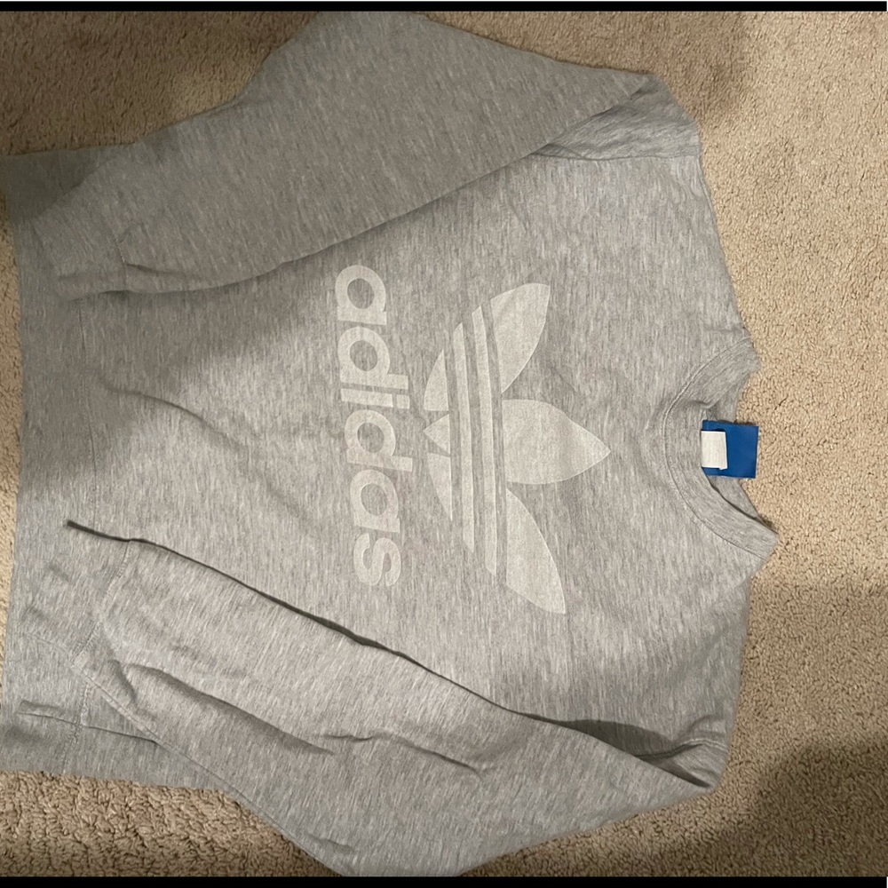 Grey adidas graphic sweatshirt. Logo on front and back.